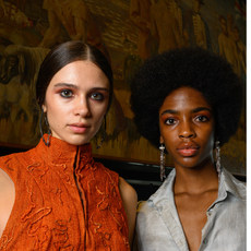 two models backstage with dark eyeshadow