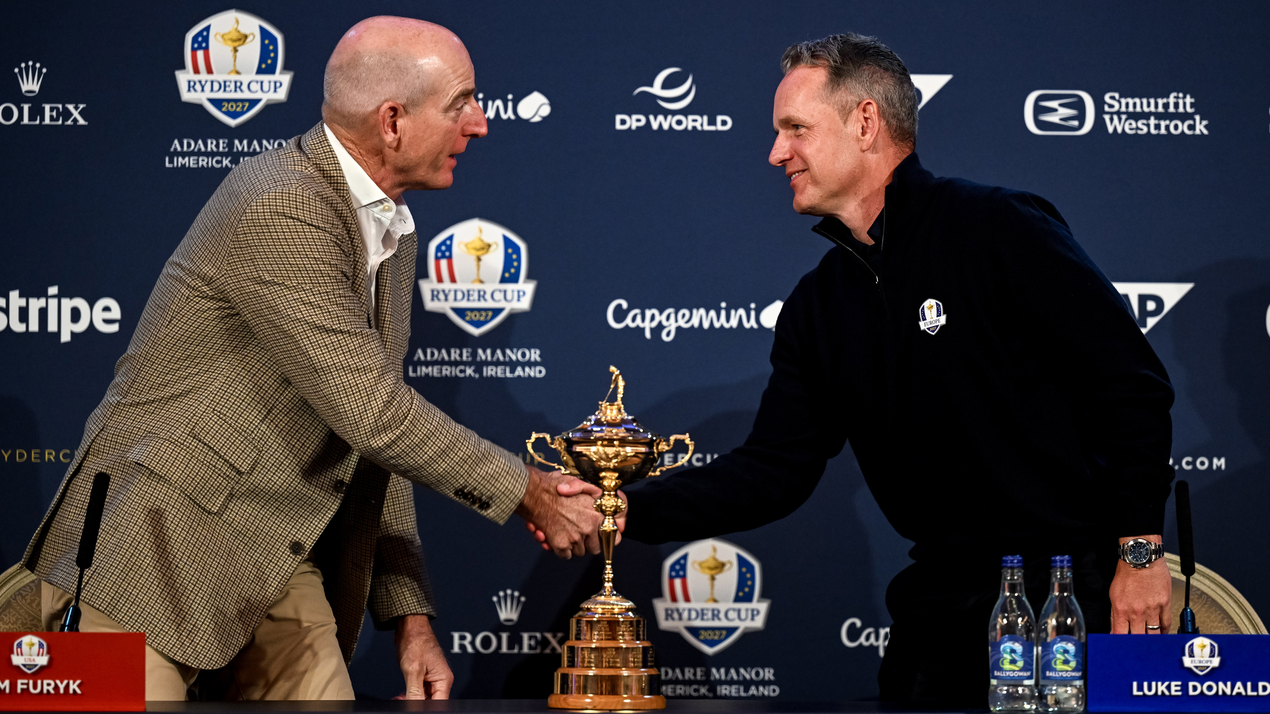 Jim Furyk and Luke Donald shake hands at a Ryder Cup press conference