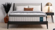 Legend Chill Hybrid Mattress on a gray bed with a black side table and large orange vase next to it