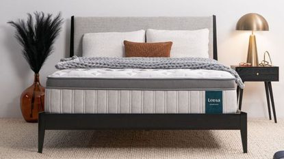 Legend Chill Hybrid Mattress on a gray bed with a black side table and large orange vase next to it