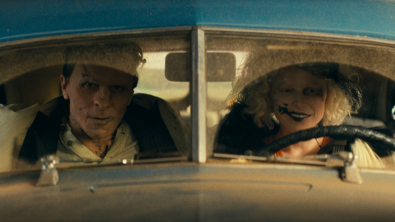 Frank and Idea seen through windshield of blue sedan that she's driving in The Bride