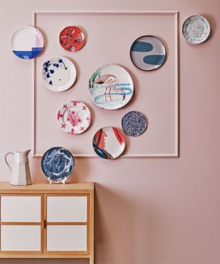 Wall decor in with plates hung in a random pattern