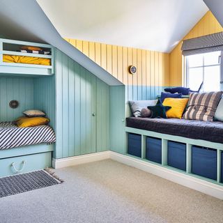 Loft conversion blue kids room with window seat and bunk beds