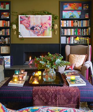 colorful living room with green walls and fireplace