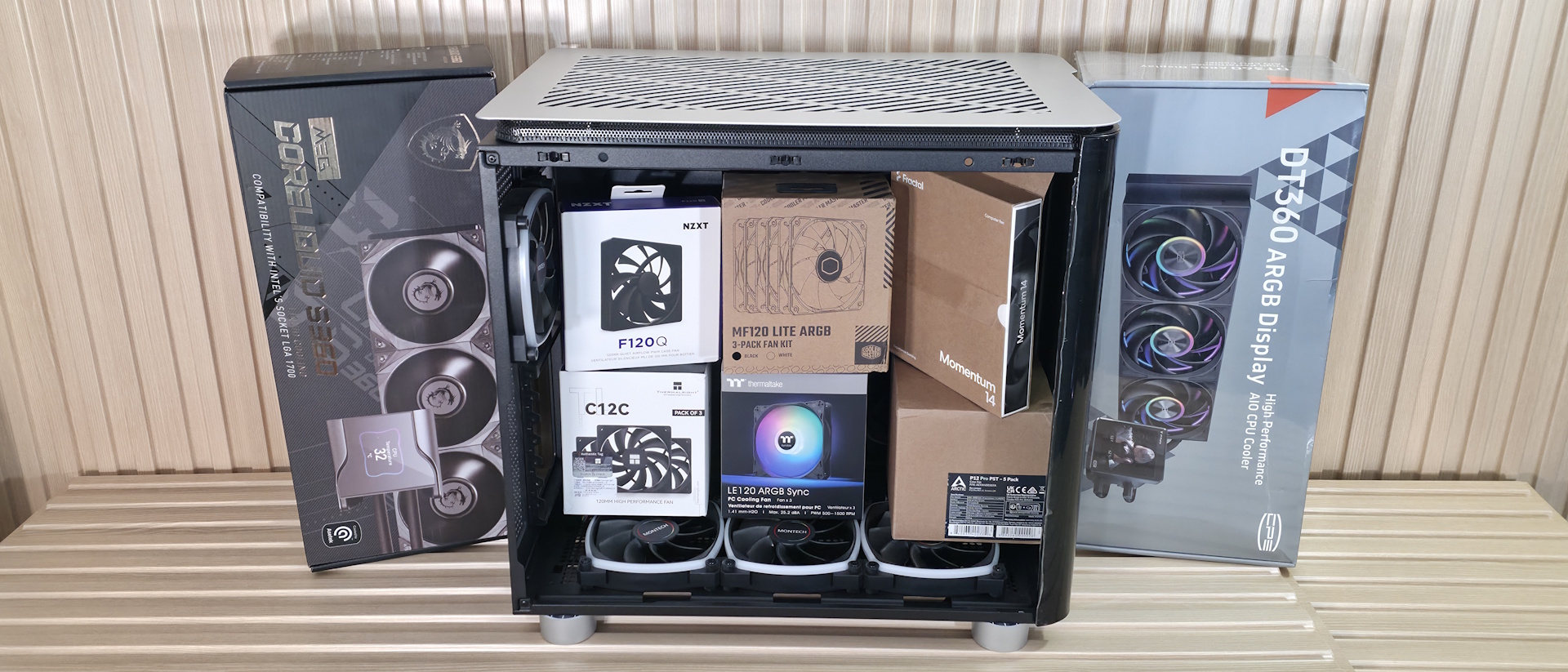 PC Case, AIO and Fans neatly lined up on a desk.