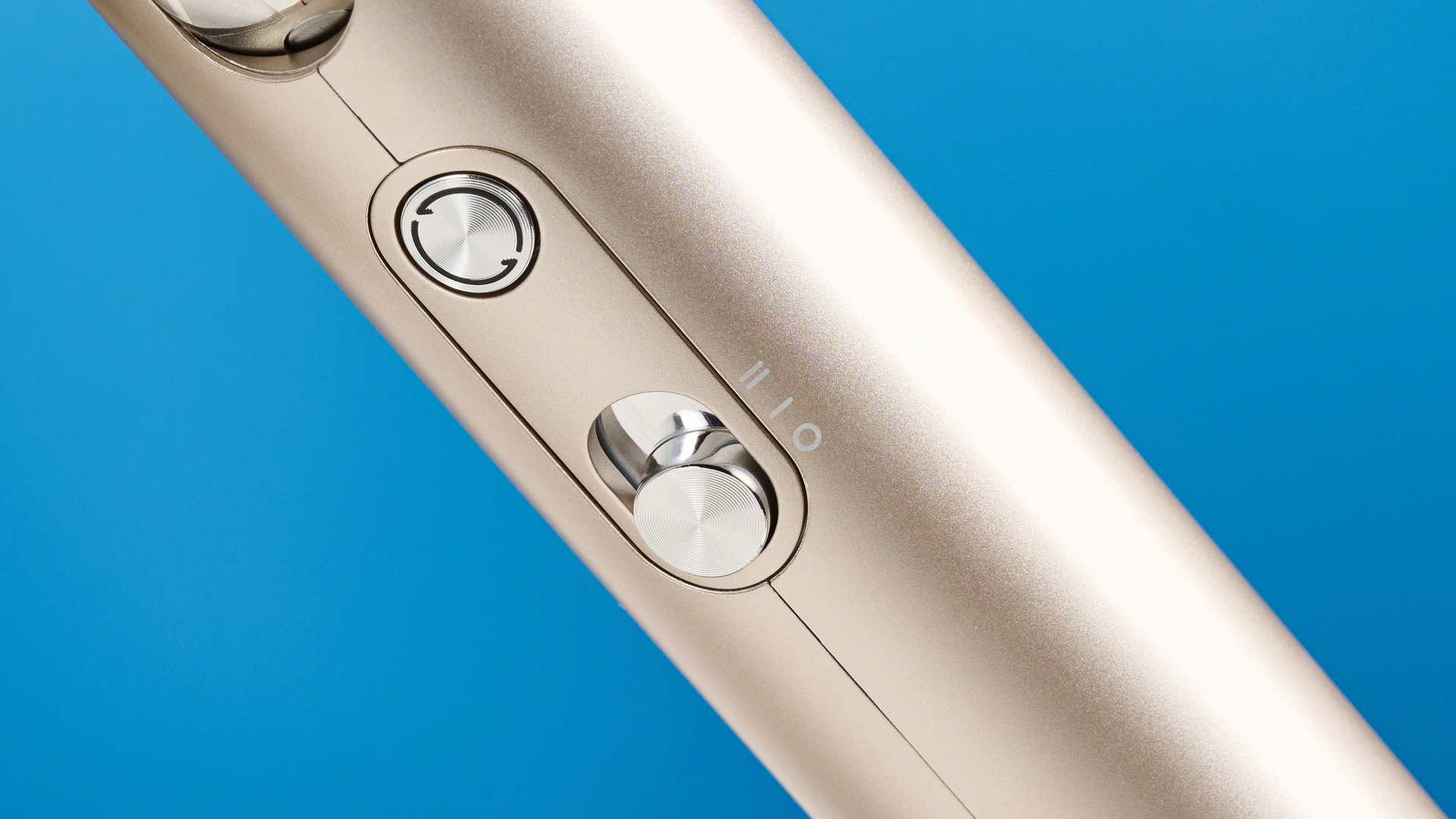 The Dreame Pocket Neo in gold photographed in front of a blue background.