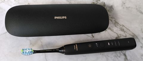 Philips Sonicare DiamondClean 9000 electric toothbrush next to charging case