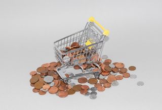 Tiny shopping trolley filled with small change