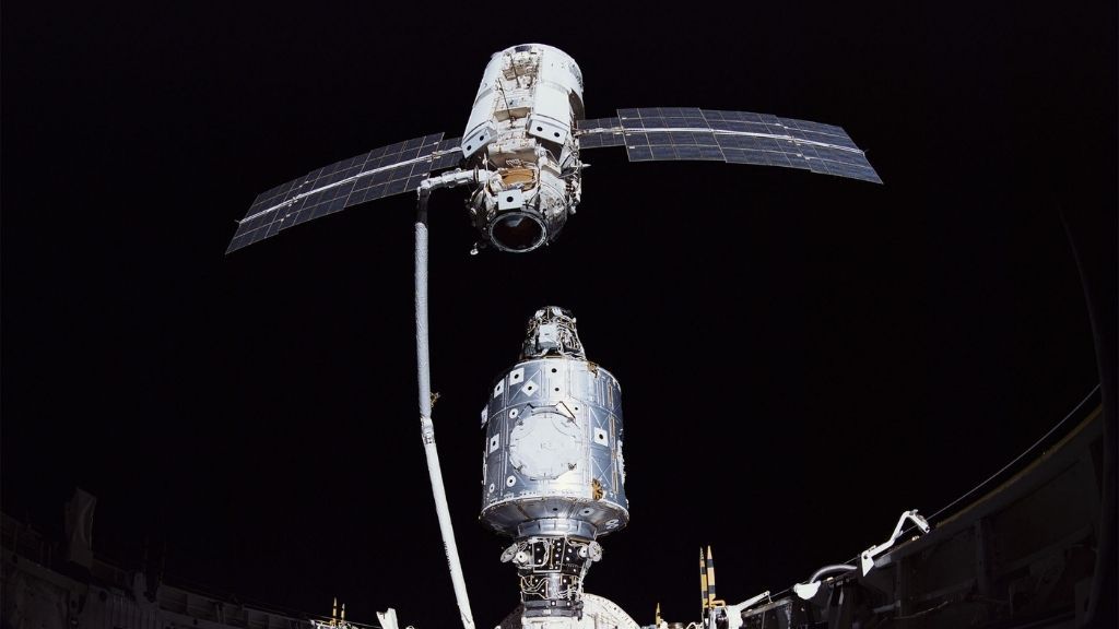 Image shows the Russian-built module Zarya (top) being aligned to attach to the U.S. module Unity in 1998