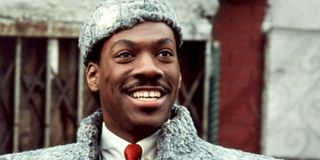 Prince Akeem (Eddie Murphy) smiles as he arrives in Queens in Coming to America (1988)