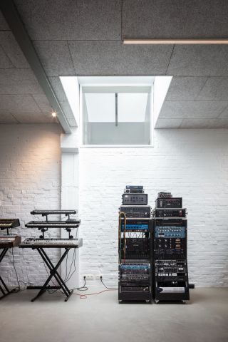 A room with a keyboard and sound system