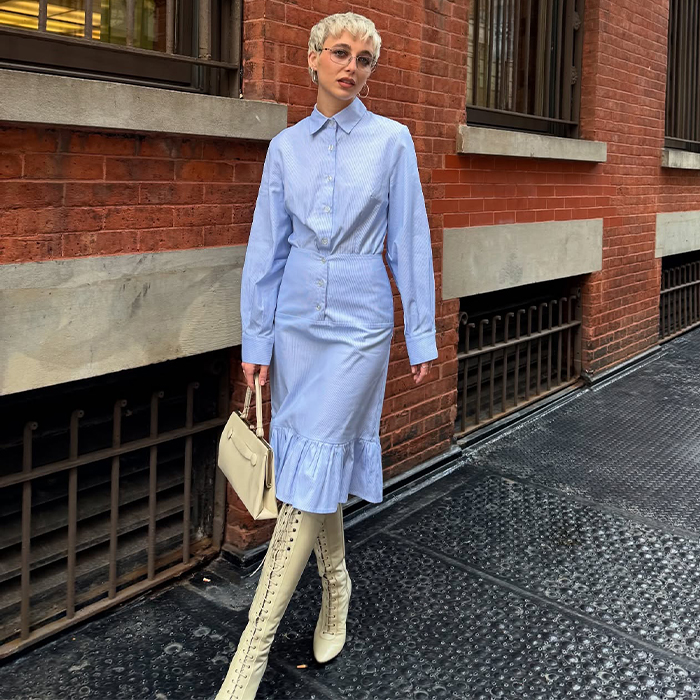 emma wears a blue set with long white boots
