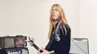 Greg Allman playing guitar, surrounded by amps 