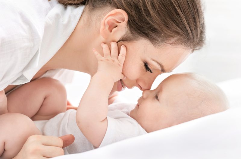 A mom cuddles close to her baby.