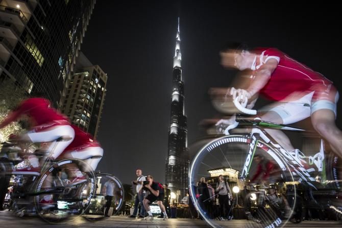 Riders were dwarfed beneath the world's tallest building.