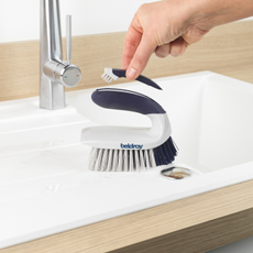Beldray Scrape & Scrub Duo - Deep Clean Handheld Scrubbing Brush on a bathroom sink.