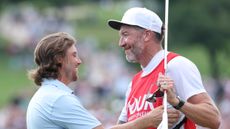 Tommy Fleetwood and Ian Finnis embrace after they won the 2025 Tour Championship
