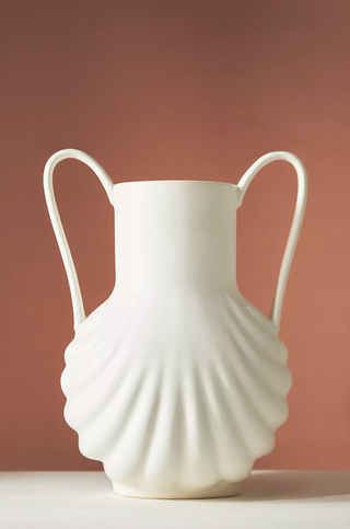 white tall vase with seashell detail at the base