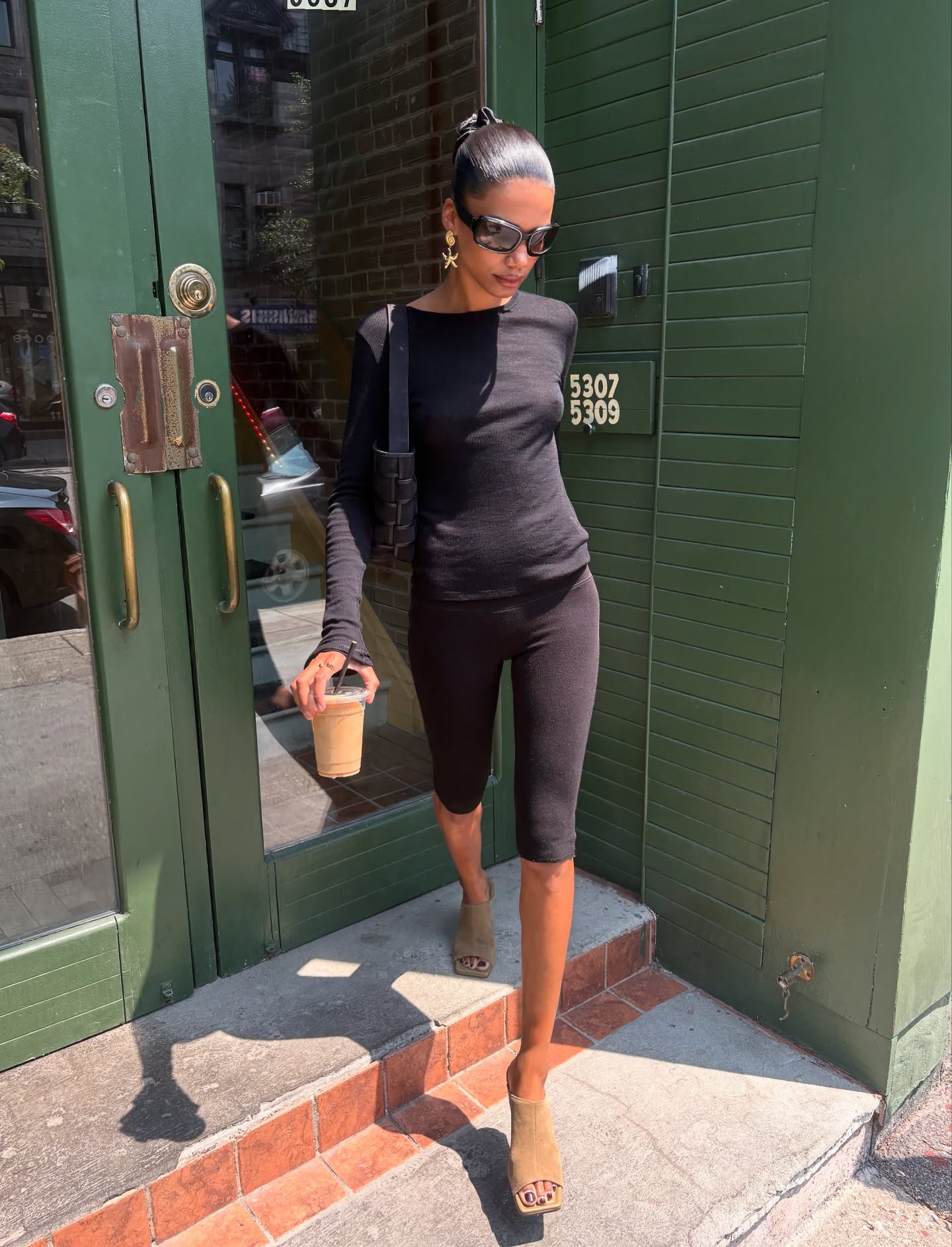 audrey roger wears an all black outfit with rang shoes