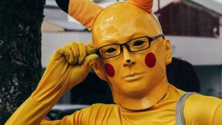Man in terrifying pikachu costume. 