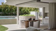 A beautiful minimalist outdoor/indoor connective space that has a pool, an outdoor kitchen and a dining space