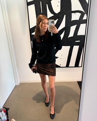 Influencer wearing a sweater and leopard-print skirt