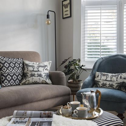 living room with sofa white wall and potted plant