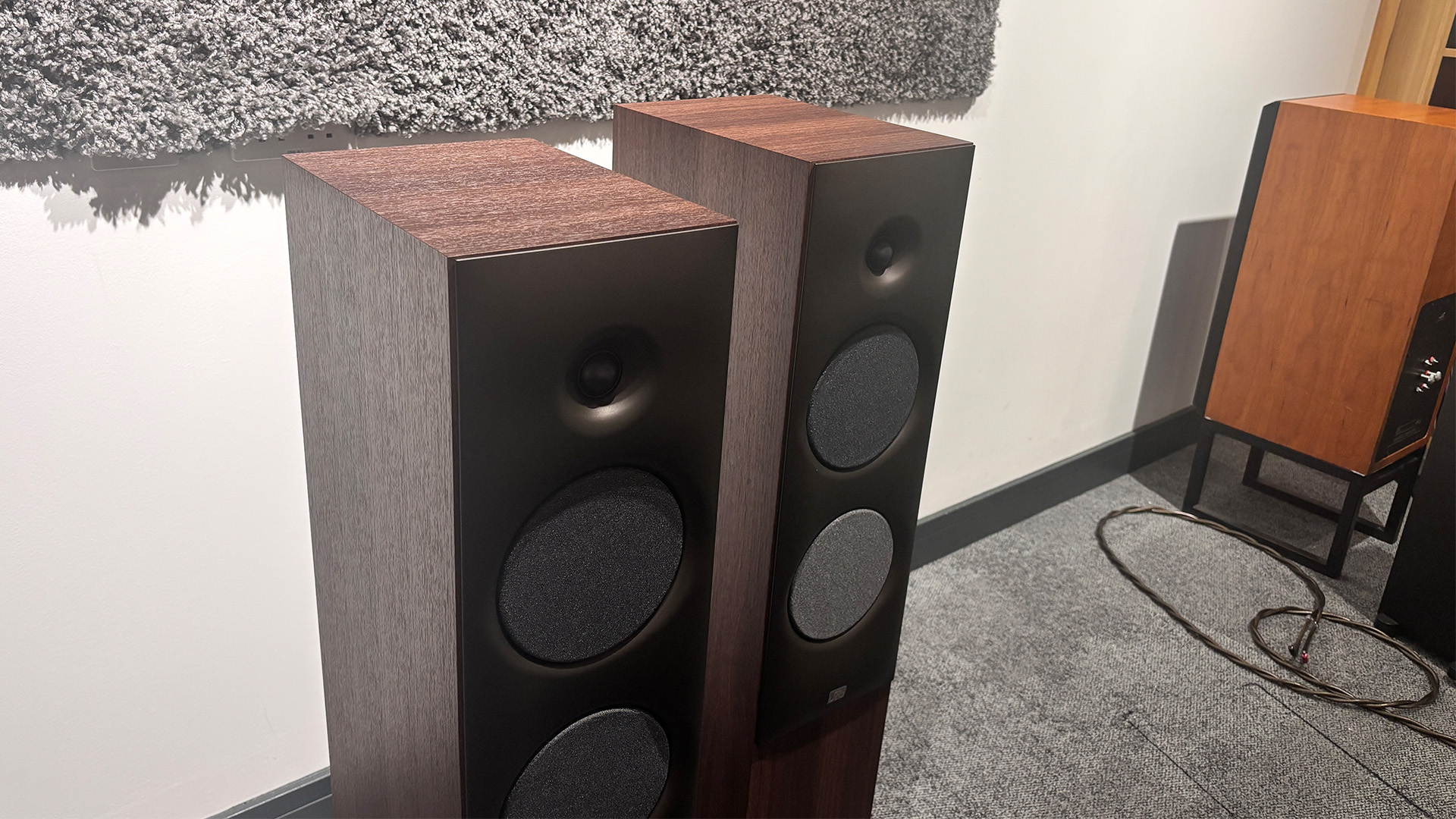 Revival Audio Sprint 4 floorstanding speakers in What Hi-Fi? test room on grey carpet with grey baffle on wall behind