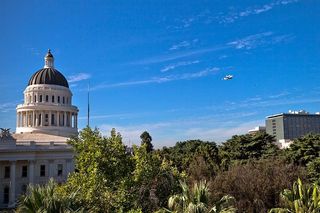 Space shuttle Endeavour and its carrier aircraft fly low over the California State Capitol Building in Sacramento on Sept. 21, 2012, during a state-wide tour over California on the way to Los Angeles, where Endeavour will be placed on public display in a