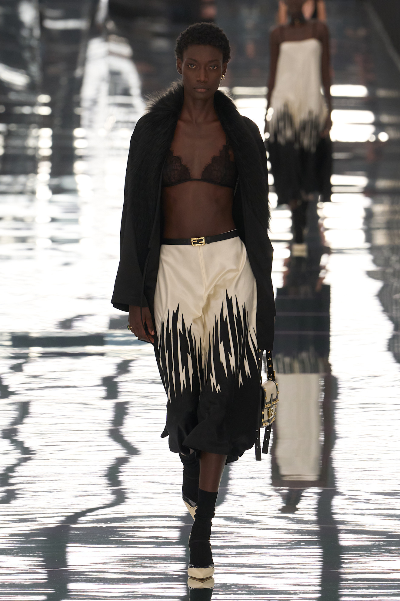 Spring/summer 2027 model wearing a bra top on the runway during fashion month.