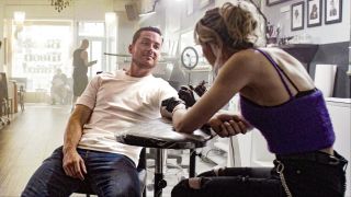 Wes Mitchell getting a tattoo in FBI: International Season 4x03