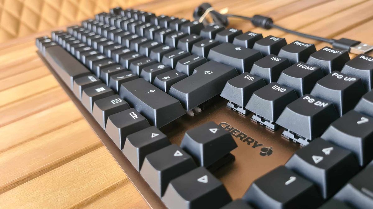 Cherry KC 200 MX gaming keyboard on a wooden table.