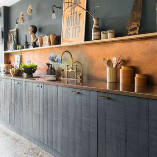 kitchen with copper splashback grey wall and kitchen sink