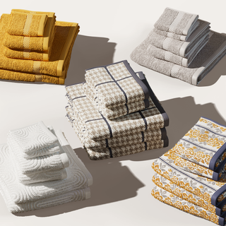 five stacks of different colored bath towels