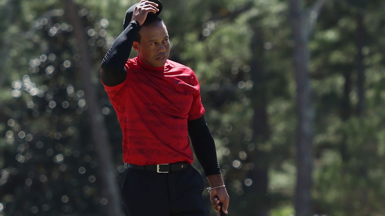 Tiger Woods tips his hat to the crowd after his final round at the 2022 Masters