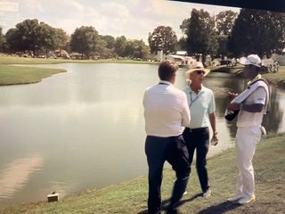 Tour officials discuss a potential penalty with Hideki Matsuyama