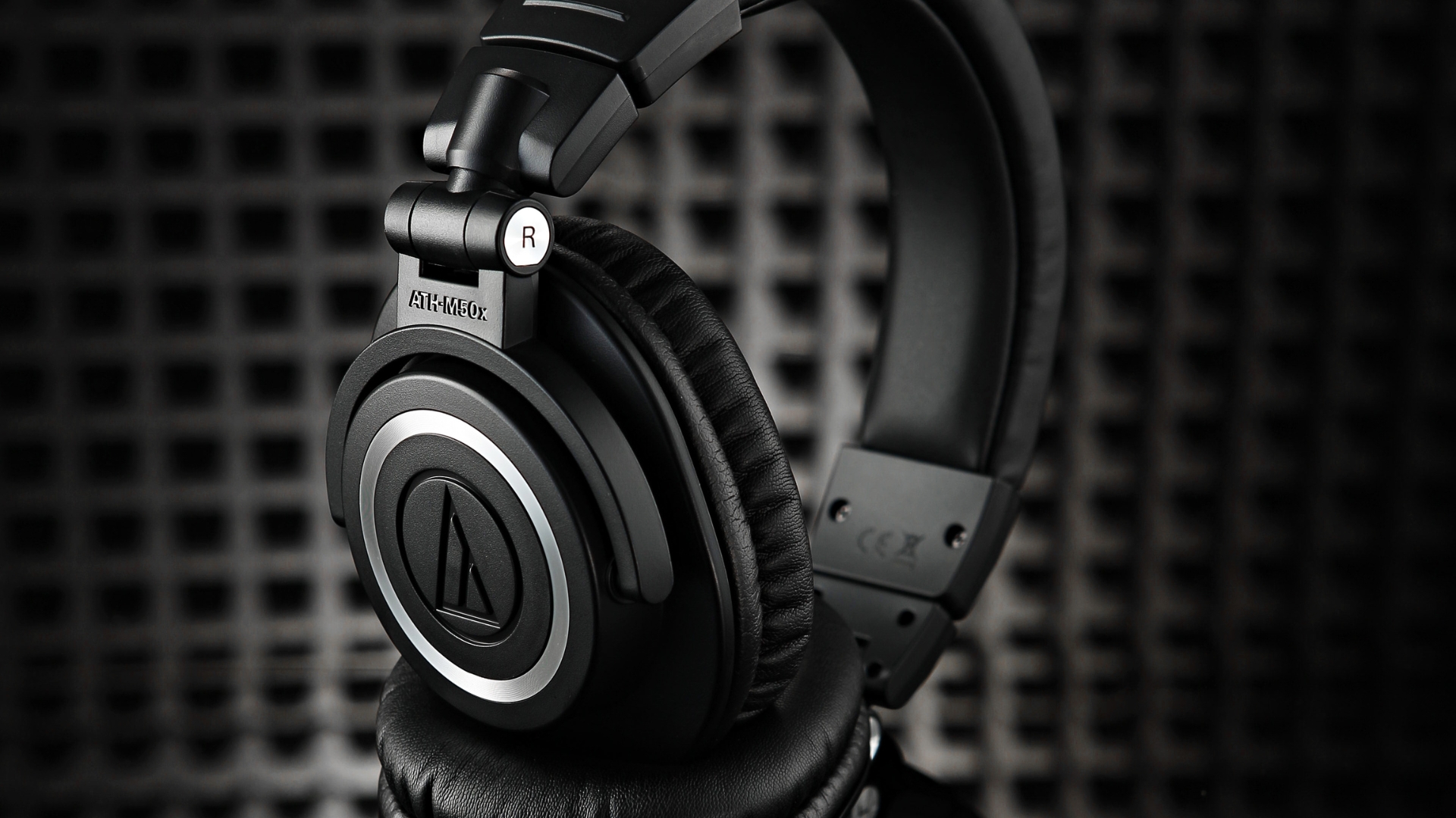 A pair of Audio-Technica ATH-M50x headphones in a studio