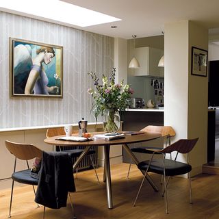 dining area with wooden floor and painting frame