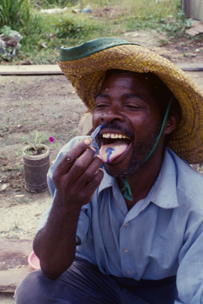 A man put blue color thing in his tounge