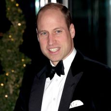 Prince William wearing a tuxedo and smiling