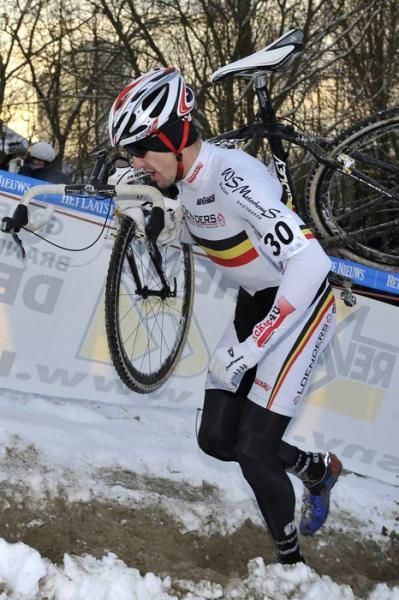 Belgium's Ben Berden shoulders his bike.