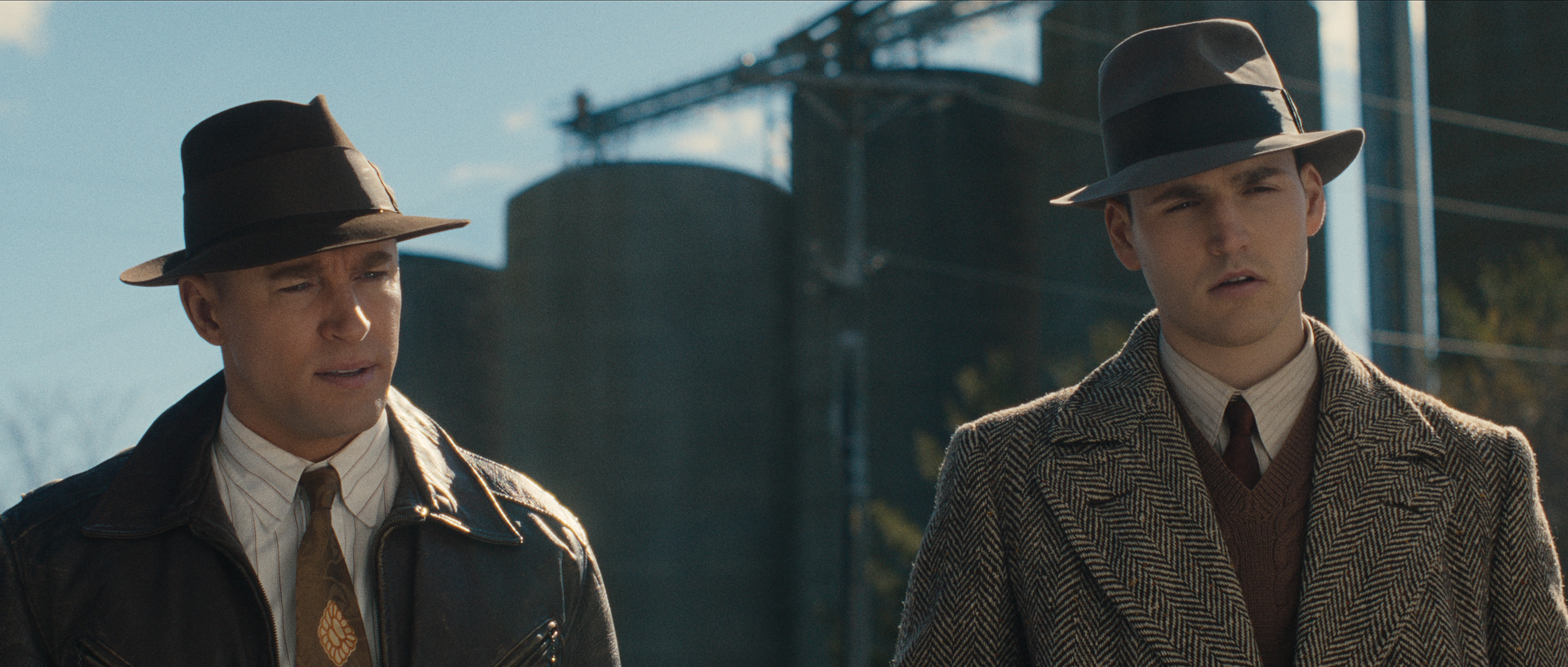Tyler Jacob Moore as Sheriff Schley and Charlie Hall as Deputy Frank Worden wearing top hats and coats in a still from monster the ed gein story