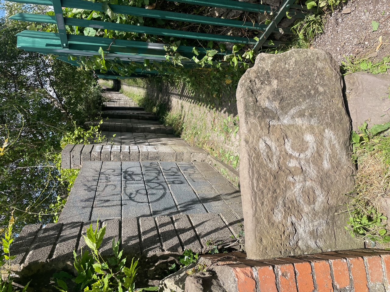 a boulder covering up the entrance to an alleyway
