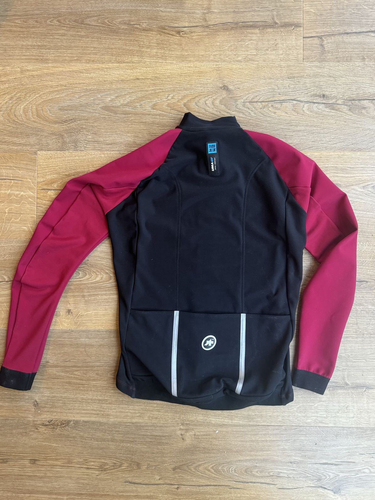 Flat lay back of the jacket, with pink sleeves