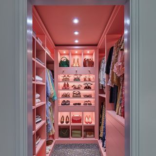 pink walk-in wardrobe with shoe and handbag storage