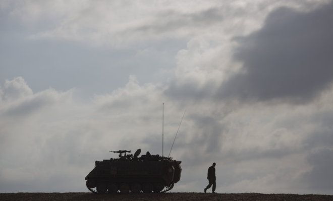 An Israeli soldier walks by his ride. 