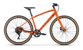 A side view of a Whyte Victoria hybrid with compact geometry, tan-wall 650B tyres and one-by gearing, in front of a plain background