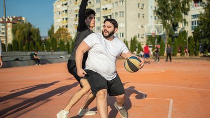 Man exercising with friends playing basketball for 30 minutes