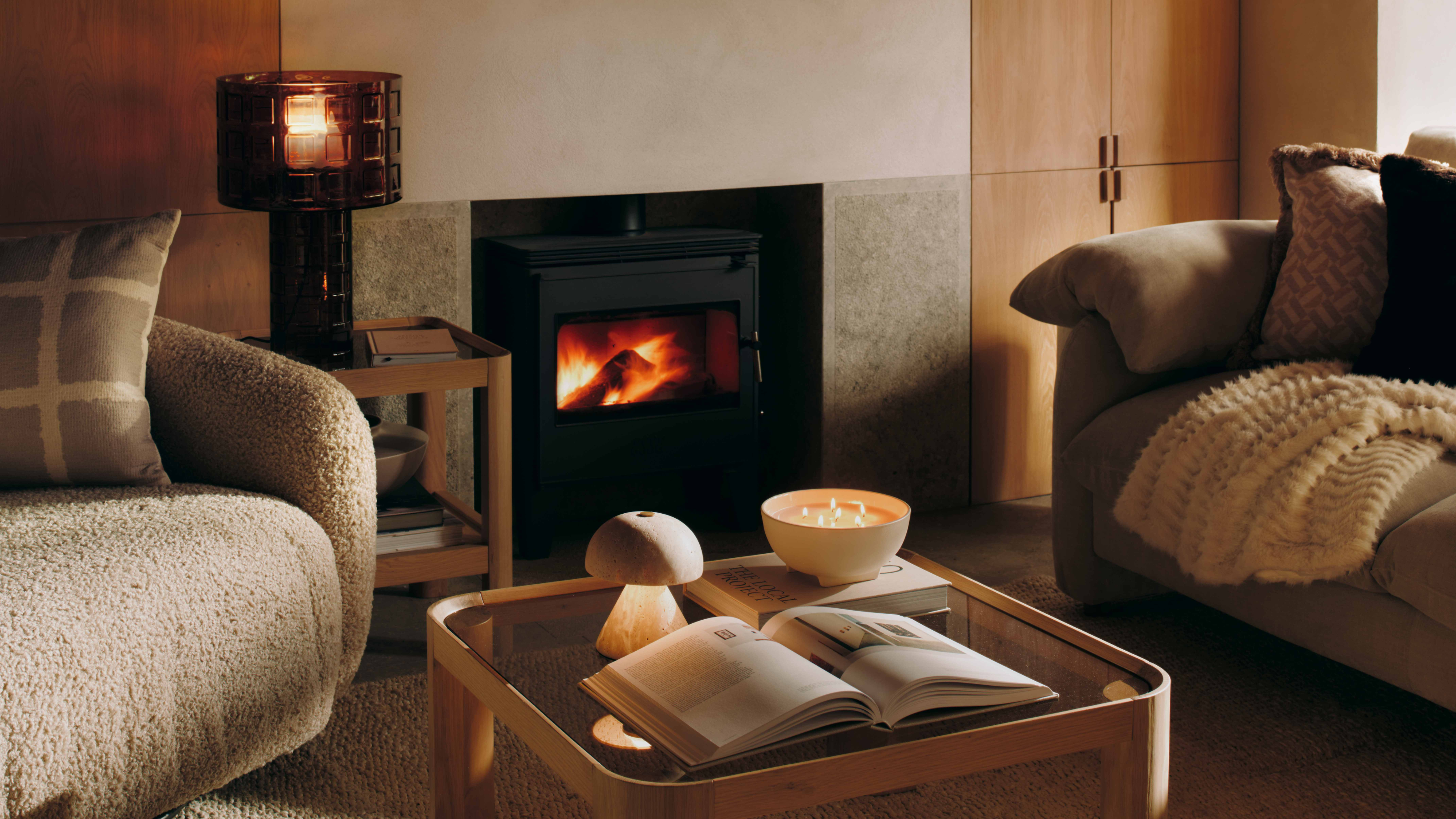 M&amp;S Double Layer Shade Glass Base Table Lamp in cosy living room with log burner.
