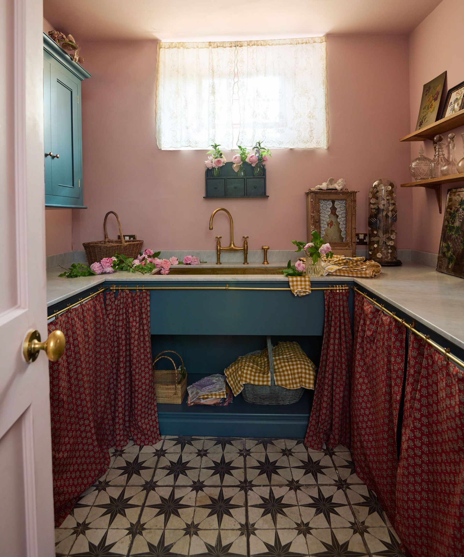 A pink and blue laundry room with patterned floor tiles